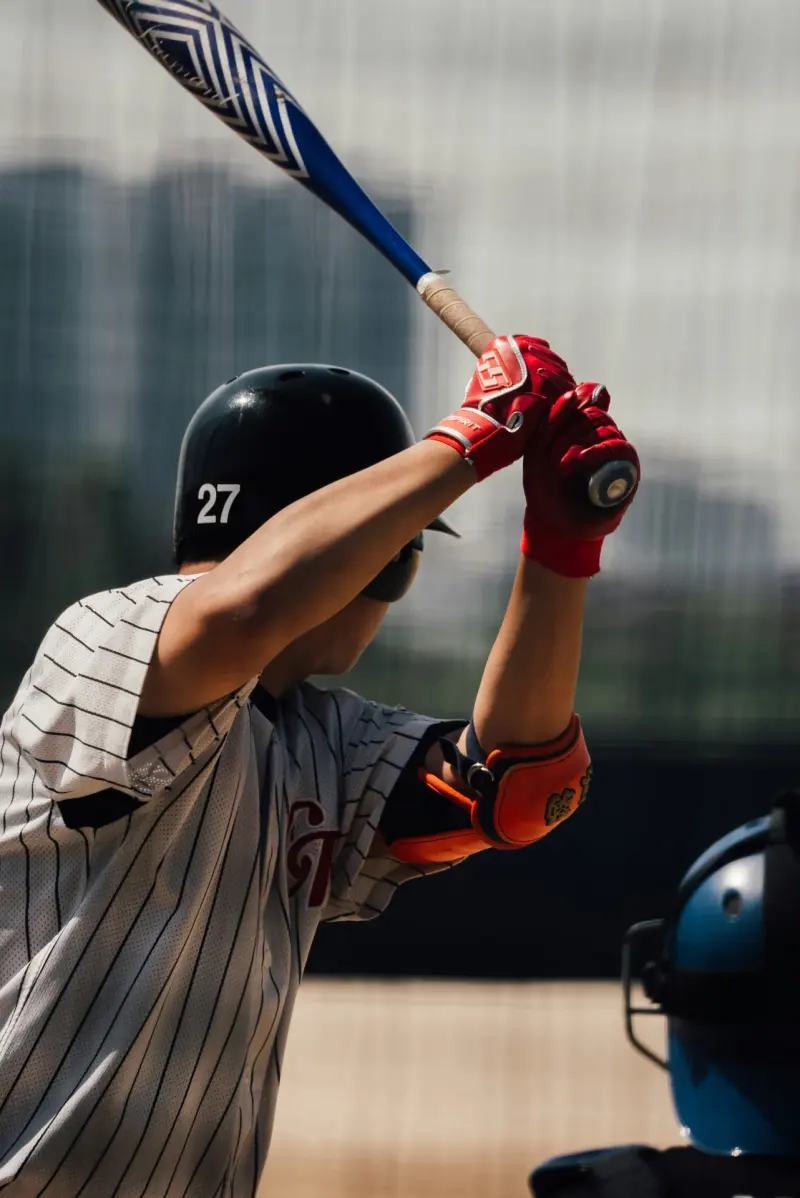 Baseball hitter in full follow-through during training session